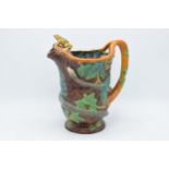 A 19th century Majolica jug modelled as a tree trunk with snake entwined and acorn leaves and
