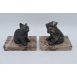 A pair of French Art-Deco bookends on marble plinths showing a cat and a dog (2). 14cm long.