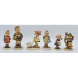 A collection of Goebel / Hummel figures to include What's That?, boy in apple tree, boy with trumpet