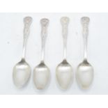 A set of 4 matching white metal tea spoons with unusual pattern to handle (4). 13cm tall.
