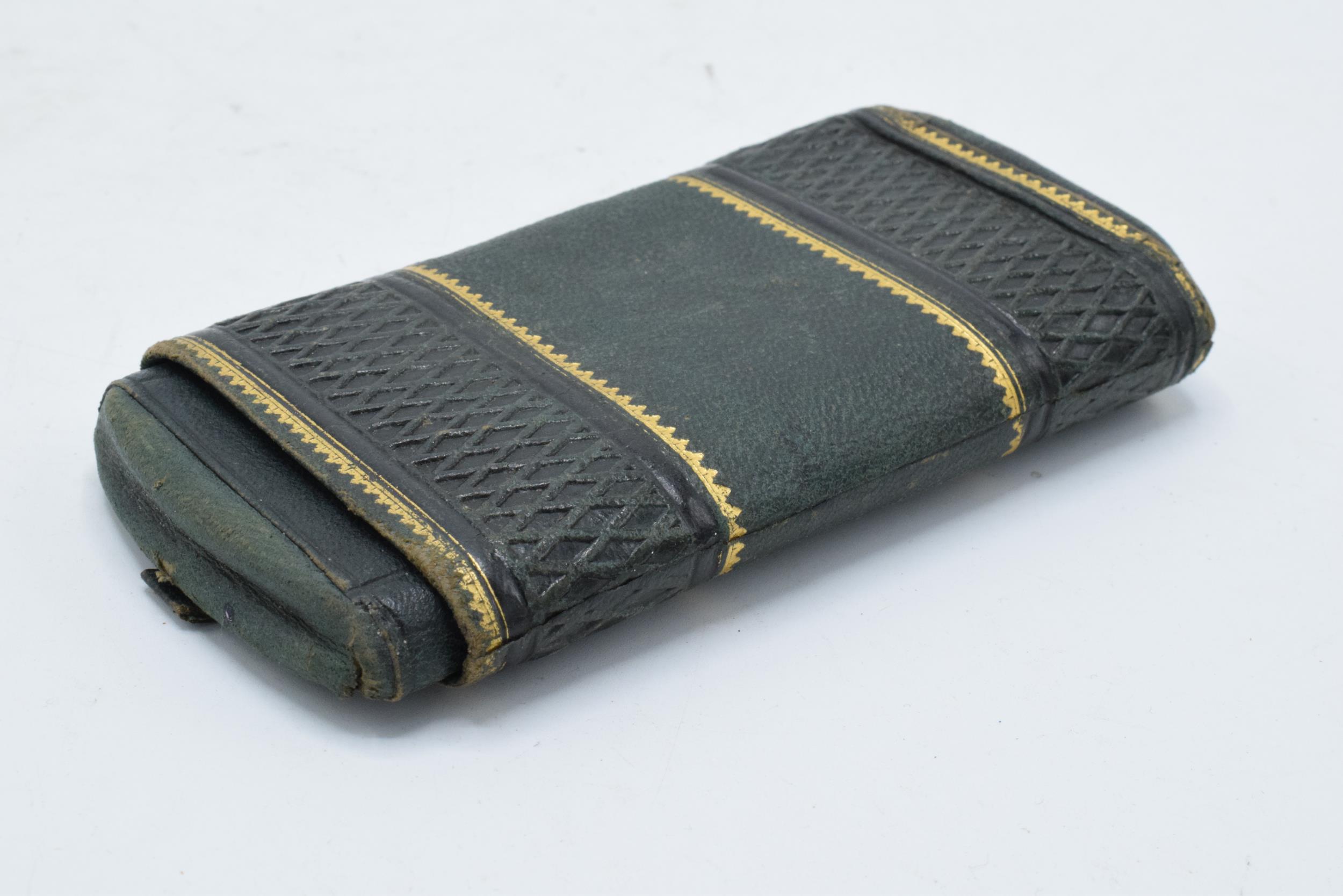 A 19th century green leather cigar case with gilt decoration. 13cm tall.