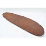 Tribal slim wooden shield, believed to be of African origin. 60cm long.