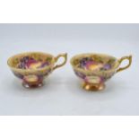 A pair of Aynsley Orchard Gold cups with gilded decoration signed by N Brunt. In good condition with