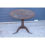 A 19th century oak tripod table with circular top on a column. 96 x 53 x 86cm tall. In good