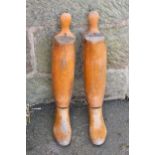 A pair of 20th century adjustable wooden boot lasts, 58cm tall.
