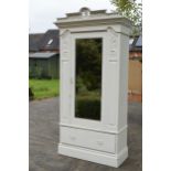 A painted white wooden Edwardian wardrobe with carved decoration and mirrored door. 115 x 54 x 227cm
