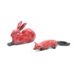 Royal Doulton flambé lying fox and hare (both af). In good condition with no obvious damage or