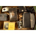 A collection of cameras and camera equipment to include a Houghton camera, various Kodak Brownies,