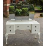 An early 20th century wooden dressing table with folding mirrors on cabriole-style legs painted