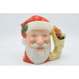 Large Royal Doulton character jug Santa Claus D6690 with sack of toys handle. In good condition with