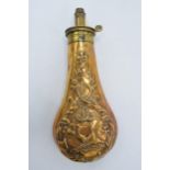 A 19th century copper and brass powder horn with repousse decoration showing pheasants amongst