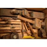 A collection of vintage tools to include planes, tape measures, gauges, a mallet, vintage saws