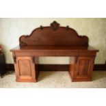 19th century figured mahogany twin pedestal buffet sideboard with raised back with carved detail.