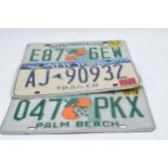 A collection of vintage American car registration plates / number plates to include New York and