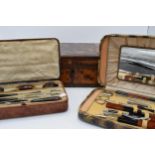 A trio of items to include a pair of cased travelling manicure sets and a wooden inlaid box with