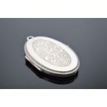 A sterling silver oval locket, 17.5 grams gross weight. 4.5cm tall.