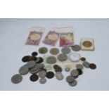 A mixed collection of UK and foreign currencies to include 5x £5 coins, commemorative coins,