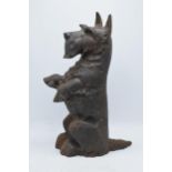 A intage cast-iron Scottie dog fire companion set stand with associated brush, height 43cm.