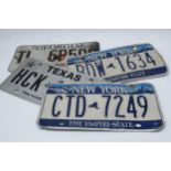 A collection of vintage American car registration plates / number plates to include New York,