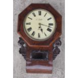 A late 19th / early 20th century drop dial wall clock with carved grape vine decoration 'C