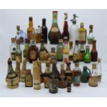 A box of vintage alcohol miniatures to include various drinks with names such as a miniature soda