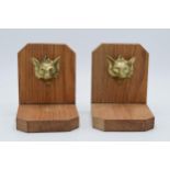 A pair of wooden bookends with cast brass foxes head (2). 13cm tall.