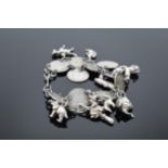A silver 3D charm bracelet with extra charms (most coins pre-1920). 38.1 grams.