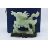 A boxed Chinese Jade (or similar) carved figure of a pair of horses on wooden plinth. 20cm long.