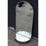 A large domed mirror with mirrored shelf with decoration to main panel. 98cm tall.