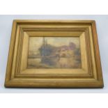 A late 19th / early 20th century gilt framed oil on board of a house by a lake. 49 x 39cm inc frame.