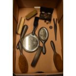 A collection of ebonised wooden brushes, trinket box, hand held mirrors etc (Qty).