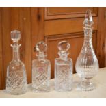 A collection of decanters to include a Royal Albert cut glass examples and 3 similar examples.