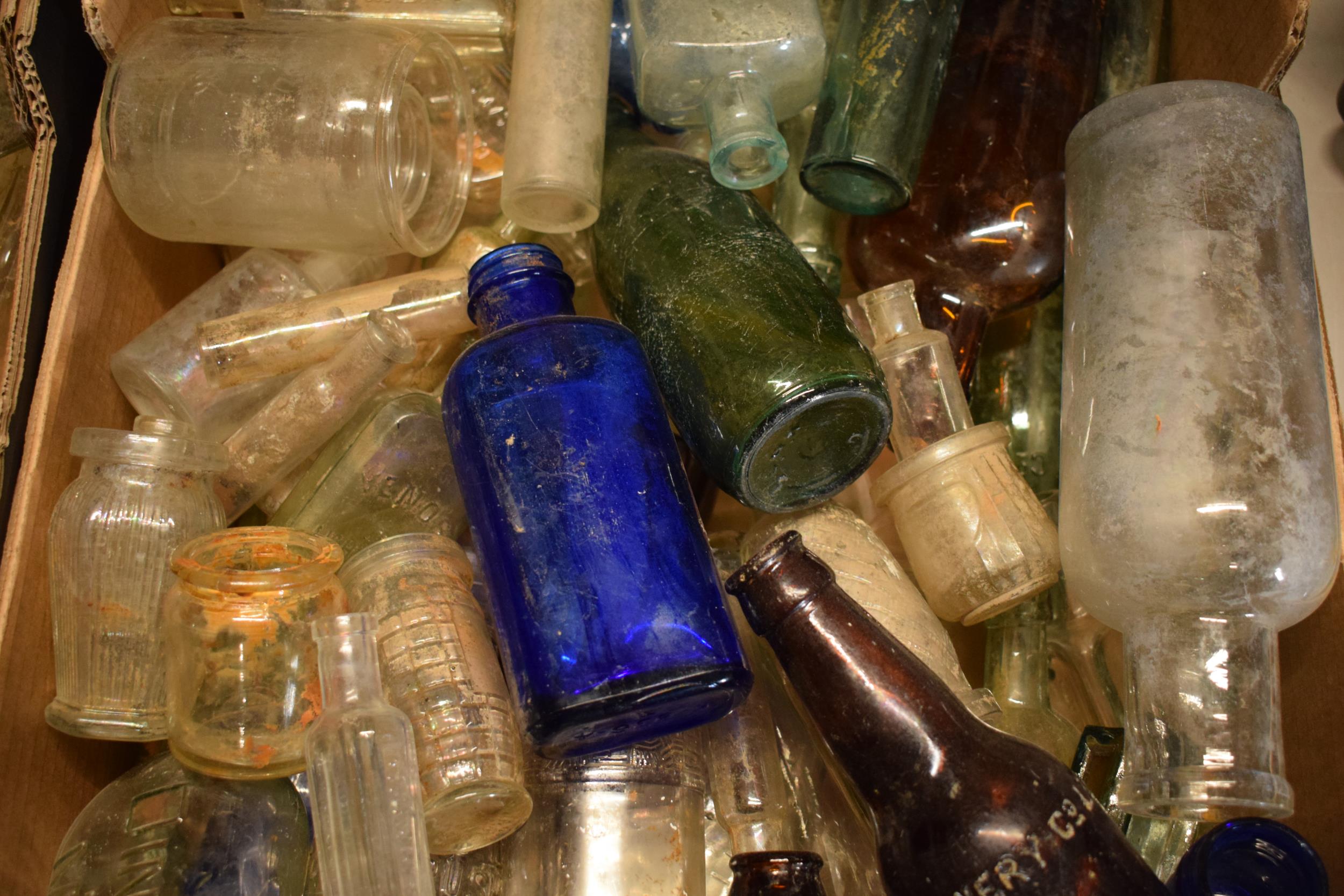 A large collection of glass bottles of varying forms and colours with some having advertising - Image 3 of 4