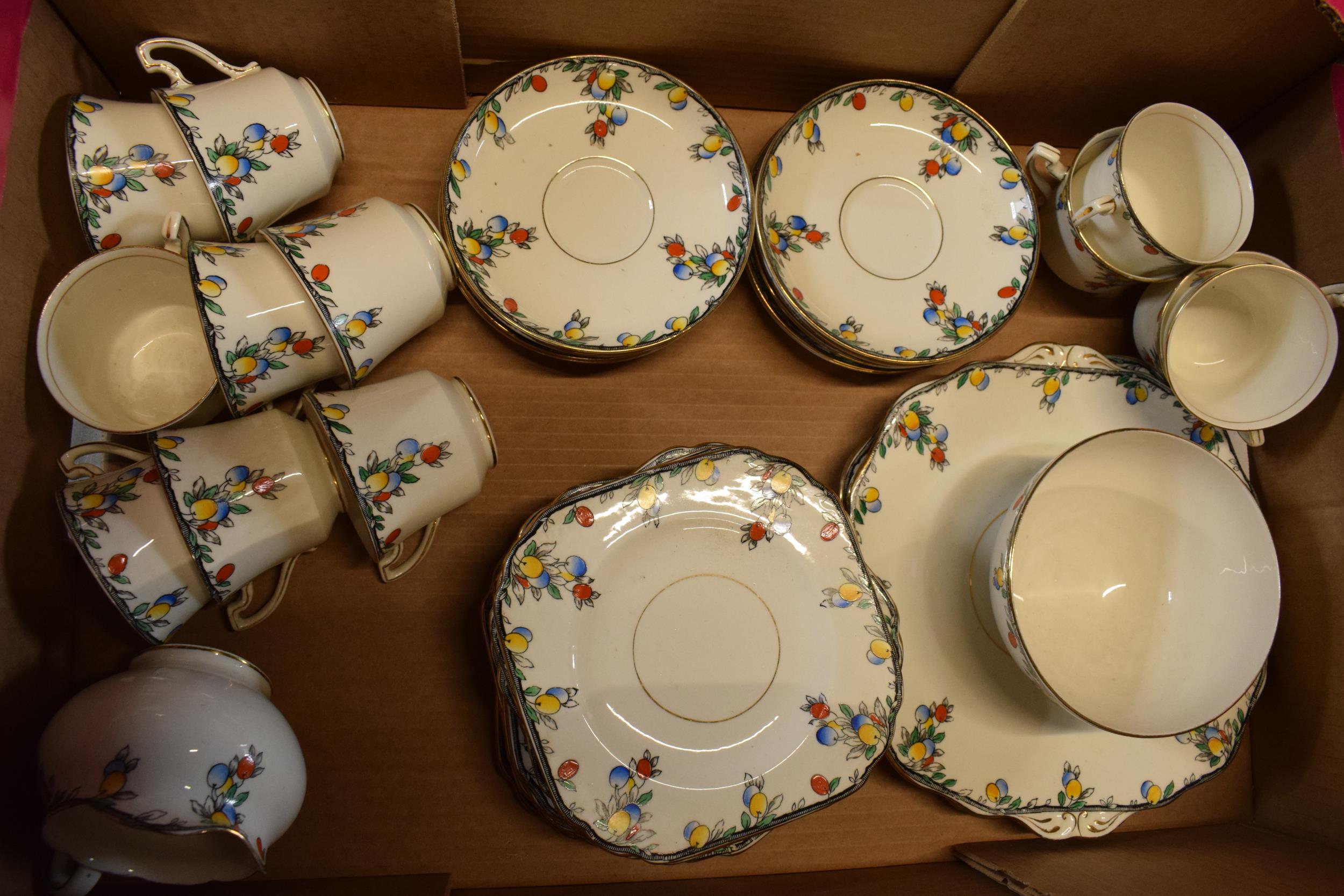 A Wetley China tea set decorated with fruits and foliage to include cups, saucers, side plates, milk