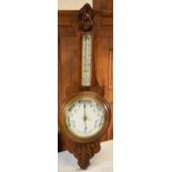 An Edwardian wooden onion-shaped aneroid barometer, 88cm tall. Collection only due to the Mercury