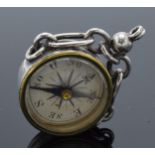 A hallmarked silver double-sided pocket watch fob with one side bearing a compass and the other a