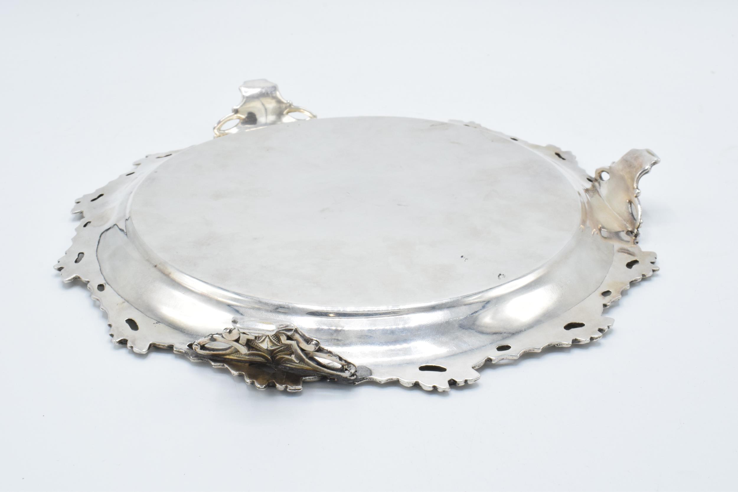 A large silver plated salver raised on three ornate feet with unusual decoration. 26cm wide. - Image 3 of 3