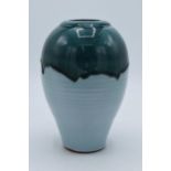 A Humfrey Wakefield studio pottery vase in a drip ware style with two-tone blue decoration. 18cm