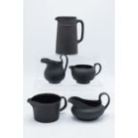 A collection of mainly 19th century Wedgwood black basalt jugs of varying forms to include a