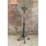 A tall and adjustable metal and copper freestanding lamp with twisted iron work, 156cm tall.
