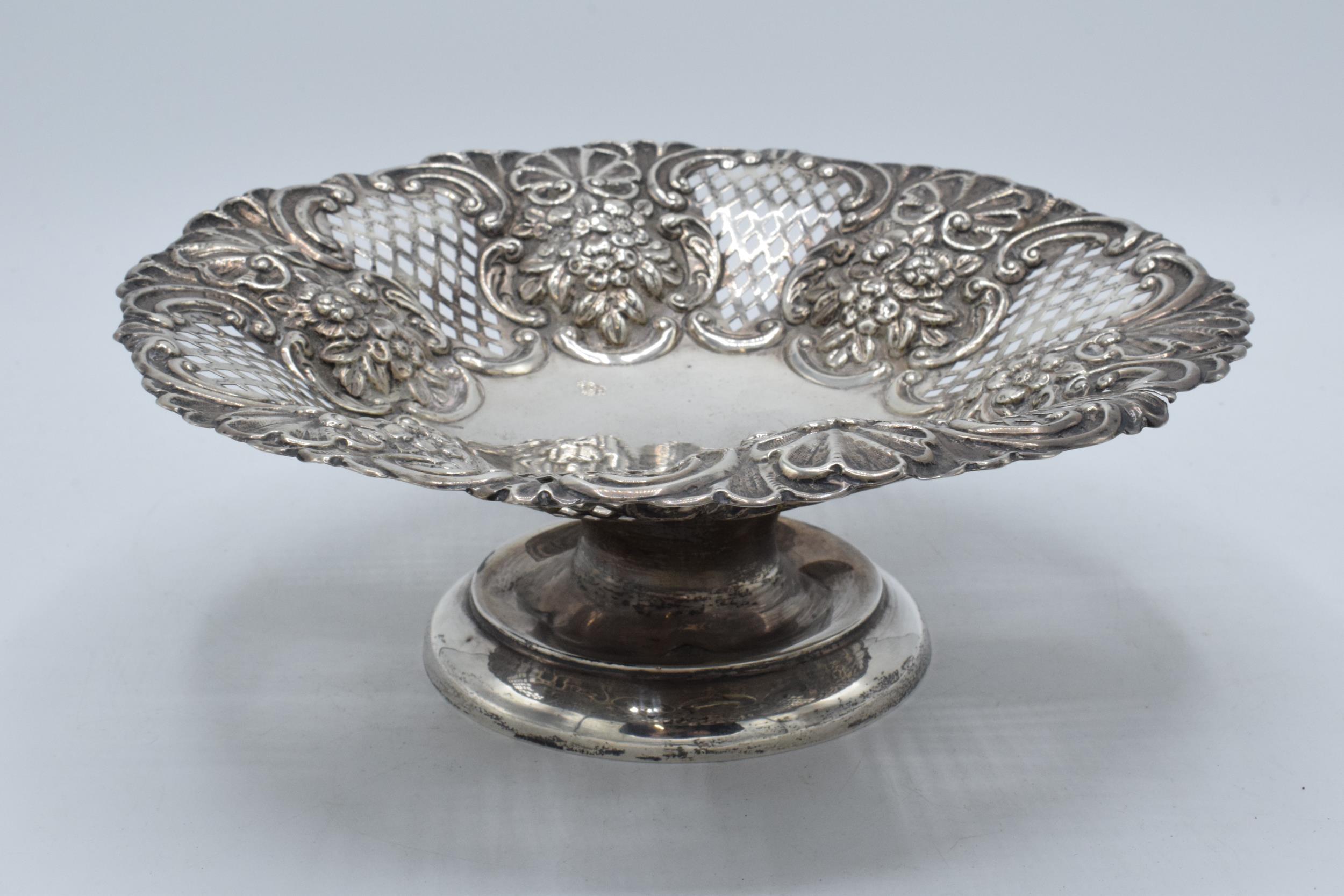 A silver pedestal dish with repousse decoration, Chester 1902, 272.2 grams. 23cm wide.