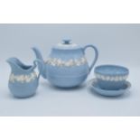 A collection of Wedgwood Queensware to include a teapot, cream jug, sugar bowl and a similar dish (