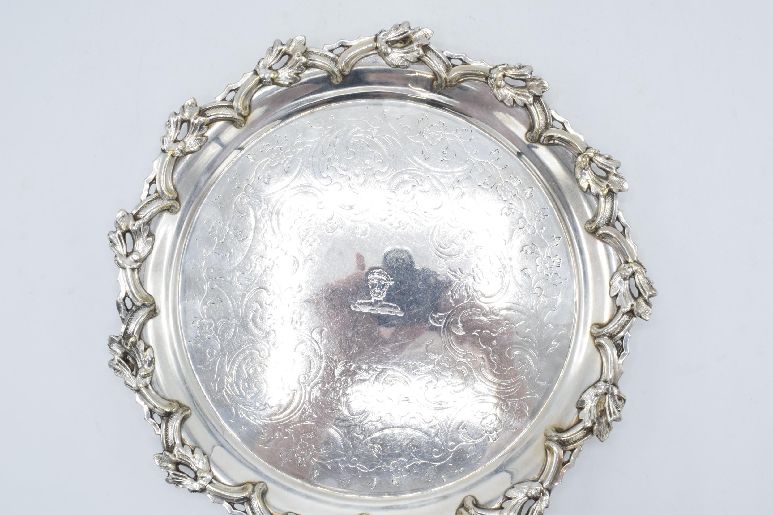 A large silver plated salver raised on three ornate feet with unusual decoration. 26cm wide. - Image 2 of 3