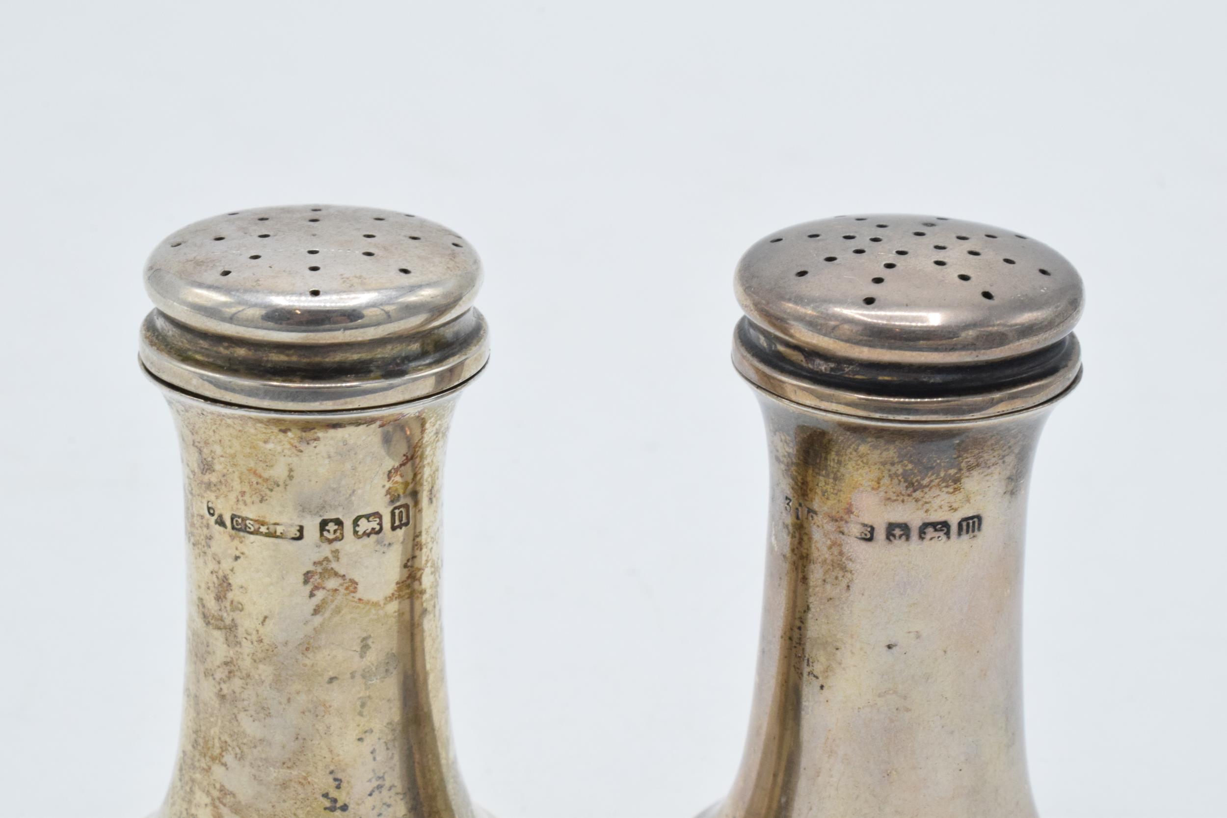 A pair of silver shakers 48.7 grams. Birmingham 1911. 6cm tall. - Image 2 of 2