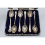 A cased set of 6 silver tea spoons with golfing decoration. Sheffield 1932. 82.2 grams.