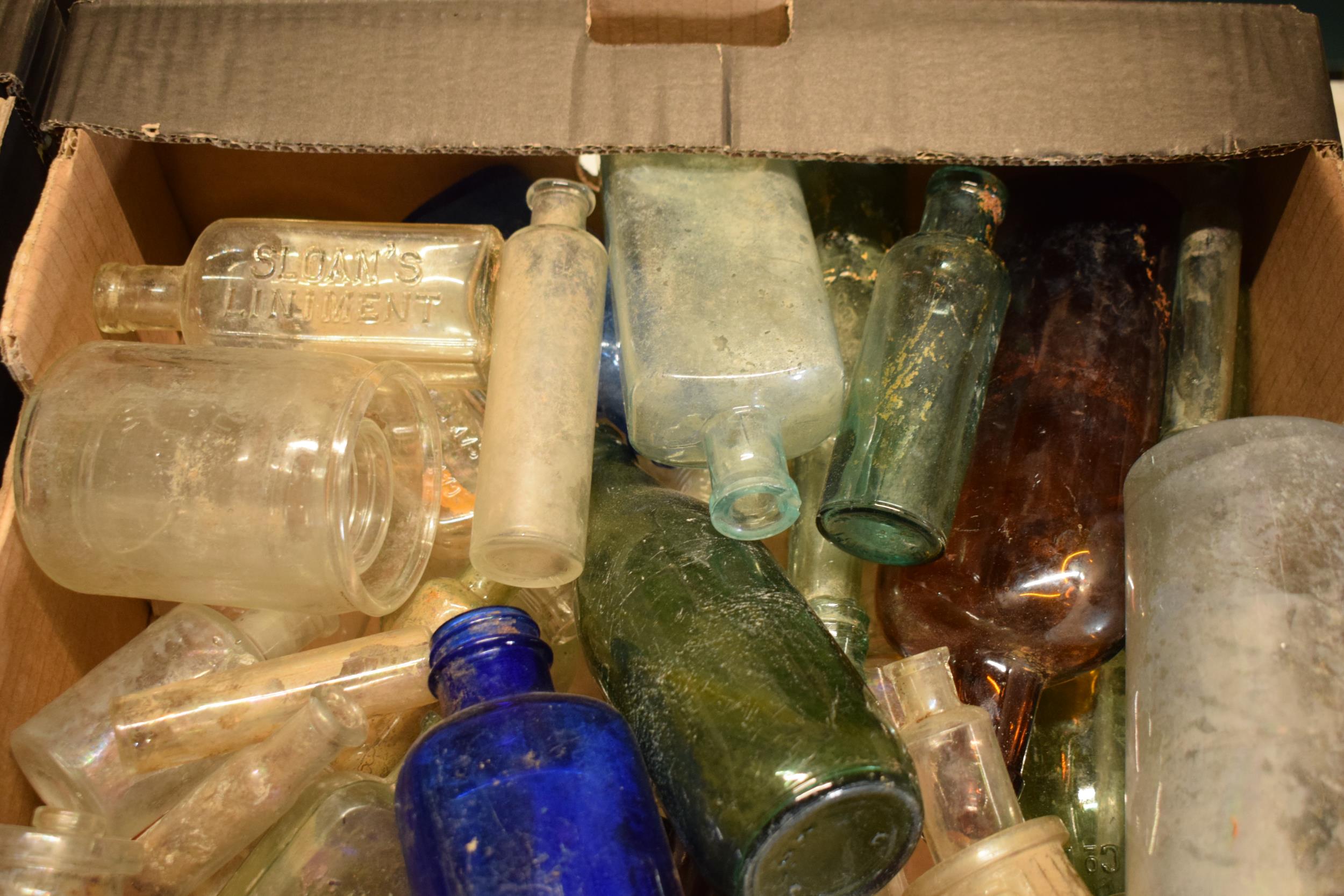 A large collection of glass bottles of varying forms and colours with some having advertising - Image 2 of 4