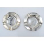 A pair of silver circular ashtrays, Birmingham 1917, A J Zimmerman, 173.3 grams. 13cm wide.