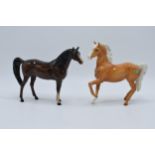 A pair of Beswick horses to include palomino prancing Arab 1261 and brown Arab Xayal 1265 (2). In