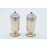 A pair of silver shakers, 62.2 grams. 7.5cm tall. Birmingham 1910. Hallmarks rubbed slightly.