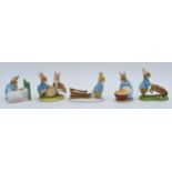 A collection of Border Fine Arts Studio World of Beatrix Potter figures to include Peter Pushing